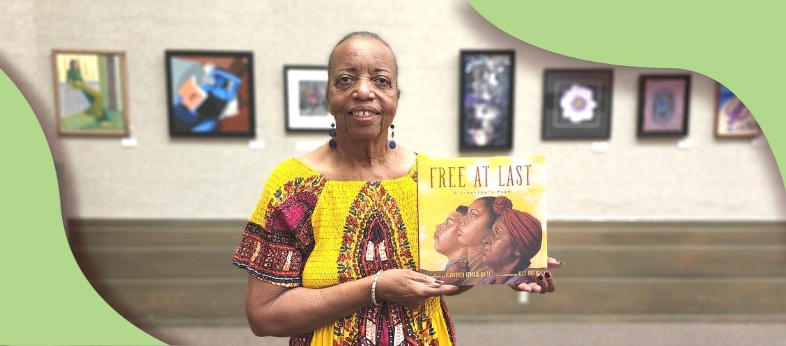 Sojourner Kincaide Rolle holding her new book