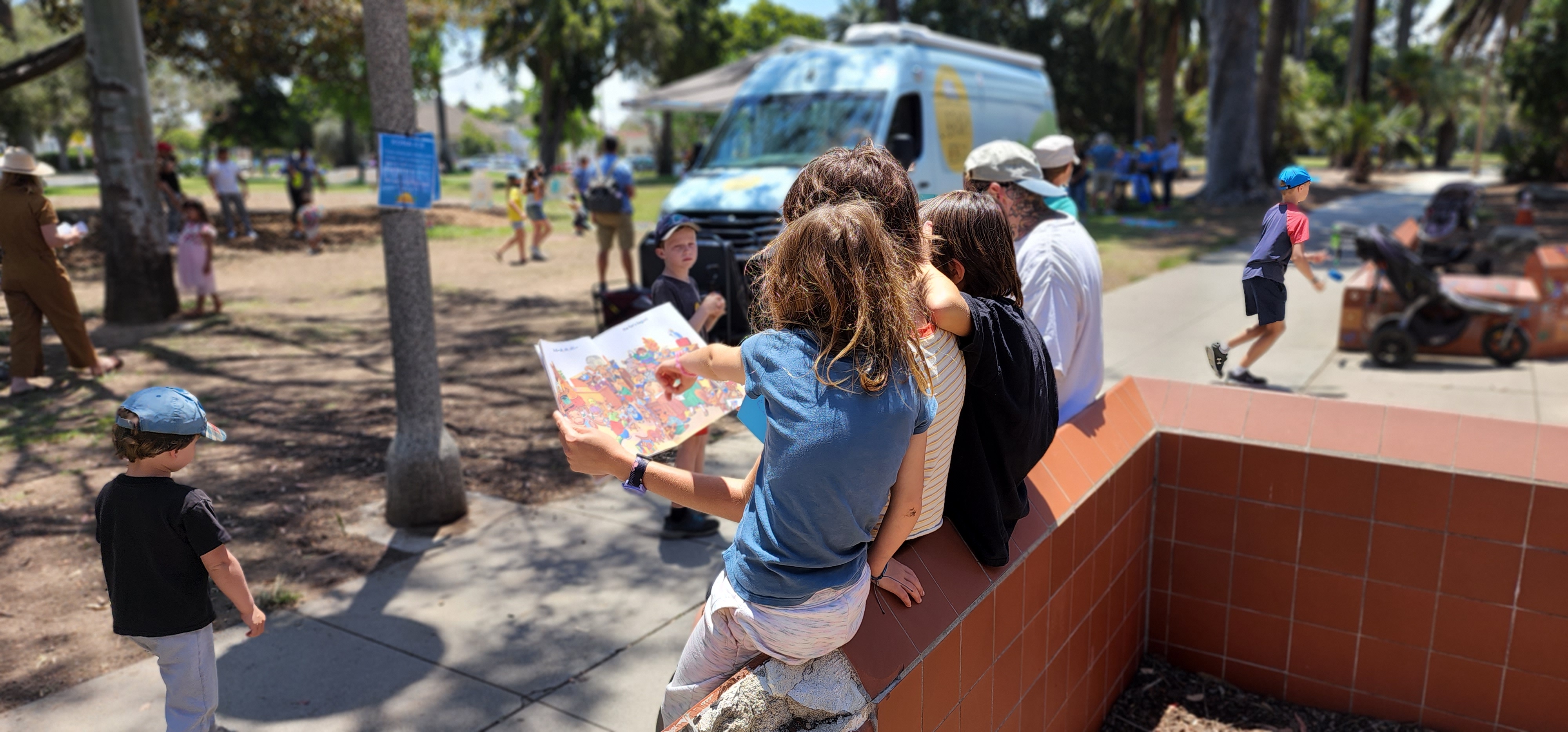 Family reading at a park