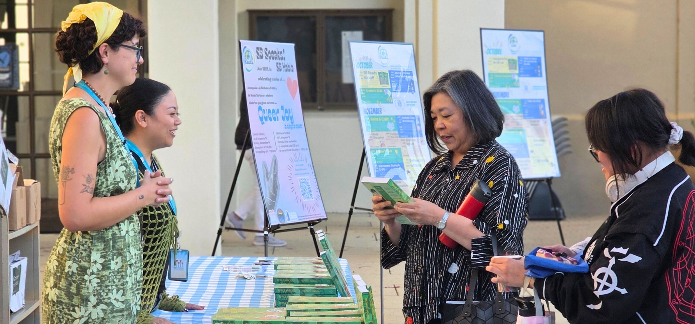 Two librarians speak to patrons at the SB Reads kickoff event