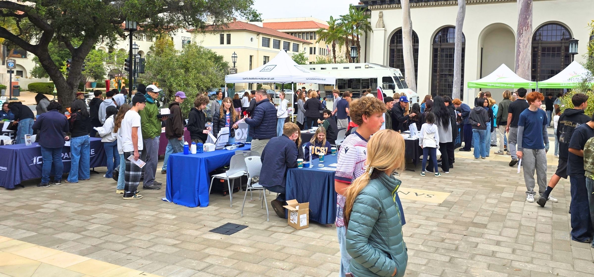 Patron browse employer booths at the Teen Job Fair