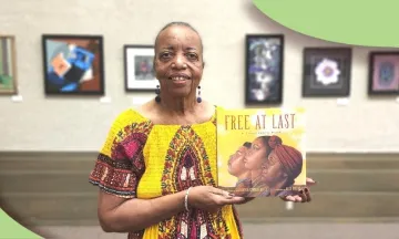 Sojourner Kincaide Rolle holding her new book