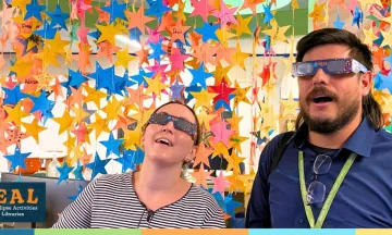 library staff wearing eclipse glasses