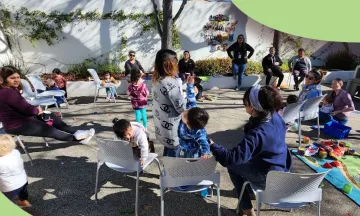 women gathering in library patio with children