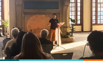 Patron reads poetry at Open Mic Night