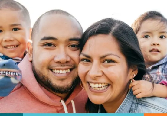 Two parents and two children smiling 
