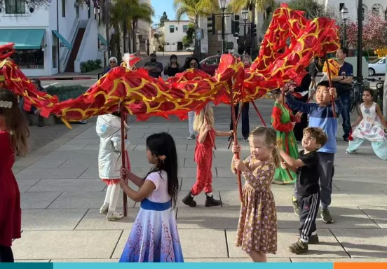 Children playing with Lunar New Year dragon