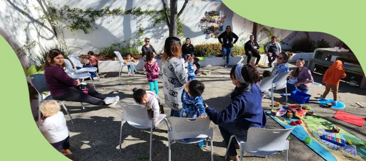 women gathering in library patio with children