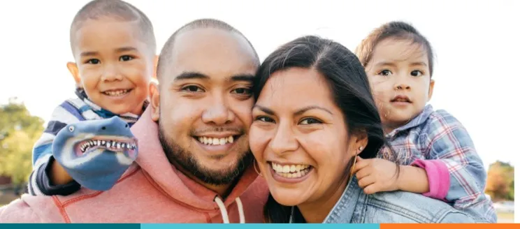 Two parents and two children smiling 