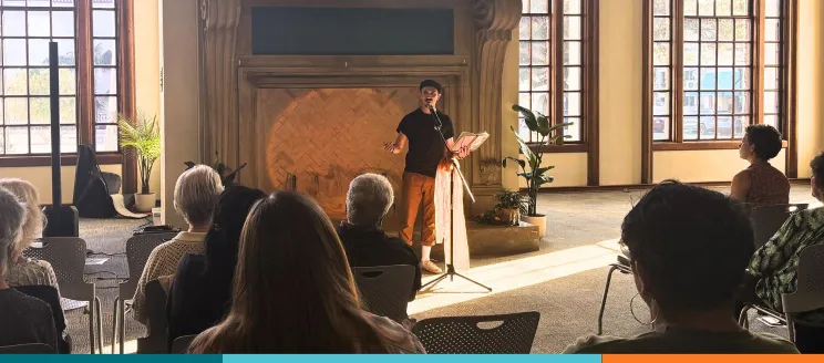 Patron reads poetry at Open Mic Night