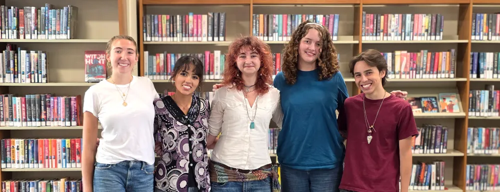 5 teenagers standing in the teen area