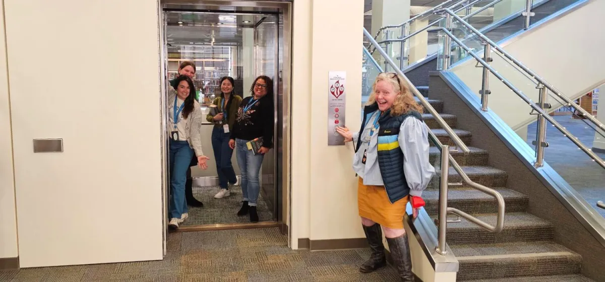 library staff gather in and around new elevator