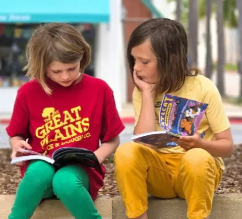 Children reading in Library Plaza