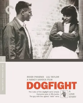 A couple stand in a doorway, the title Dogfight sits below
