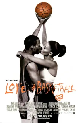 A couple kiss with two hands pressed against a basketball